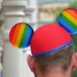 A guest wears a Pride-themed Mickey ears hat at the Magic Kingdom at Walt Disney World in Lake Buena Vista on June 3. [ JOE BURBANK | AP ]
