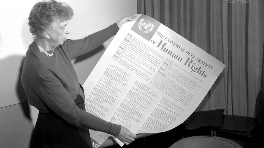 Eleanor Roosevelt pushed hard for the Declaration of Human Rights. Here she holds a poster of the declaration in English. [Exact date unknown] [ Provided ]